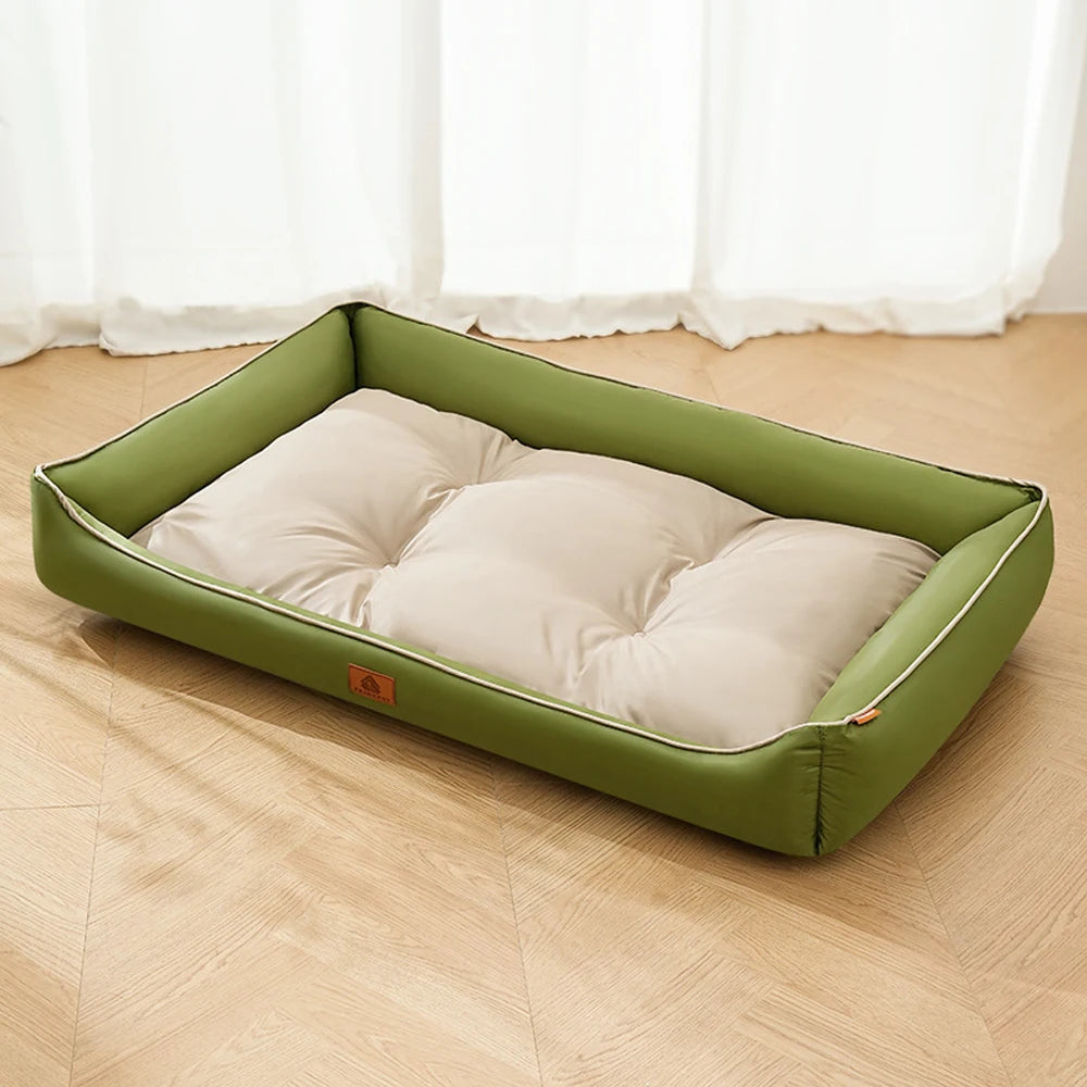 A rectangular olive green corduroy pet sofa bed for dogs and cats resting on a light wooden floor.