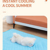 A light blue quilted dog mat is shown on a wooden floor next to a bed.