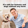 A man is sitting on a couch with a dog, demonstrating a portable ultrasonic dog repellent device.