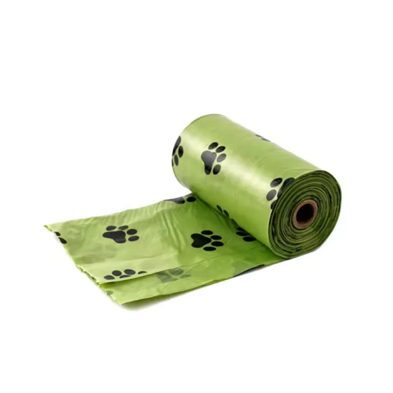 Paquets de sacs pour excréments de chien verts avec des empreintes de pattes noires pour le nettoyage extérieur