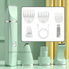 A green pet grooming kit with four attachments, including a handheld trimmer and various combs and brushes.