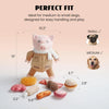A pink piggy shaped dog chew toy is shown next to various sized dog treats and a measuring tape.