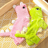 Pink and lime green fleece dog hoodies with animal ears lying on a striped fabric