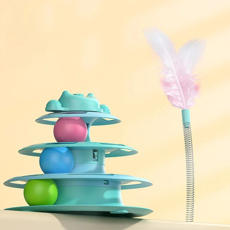 A stack of colorful, interactive cat turntable toys with rolling balls and a pink feather wand against a light background.