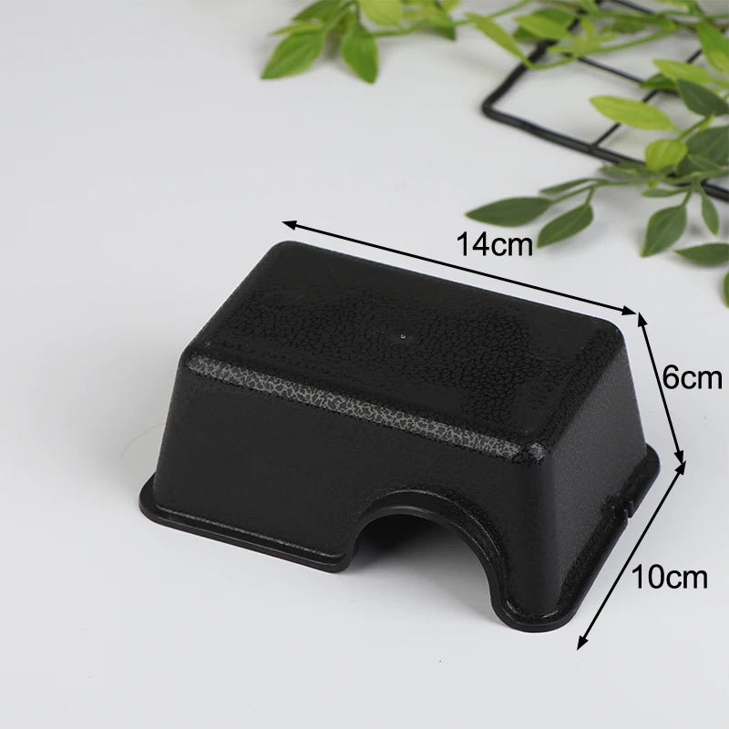 Black reptile and small animal hide box with dimensions 14cm by 6cm and 10cm.
