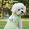 A white poodle wearing a light green cooling vest with a built-in fan for summer protection.