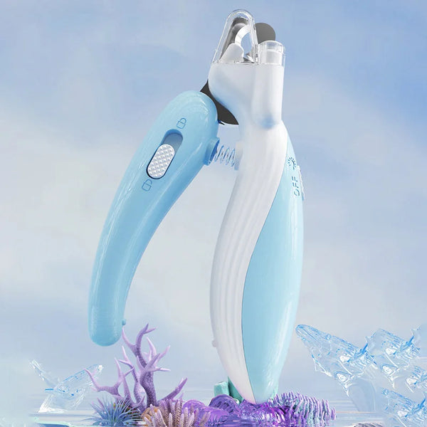 A light blue professional pet nail clipper with an LED light is shown against a blurred background of ice and purple foliage.