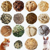 A collection of natural grass chew balls and a small rabbit pet.