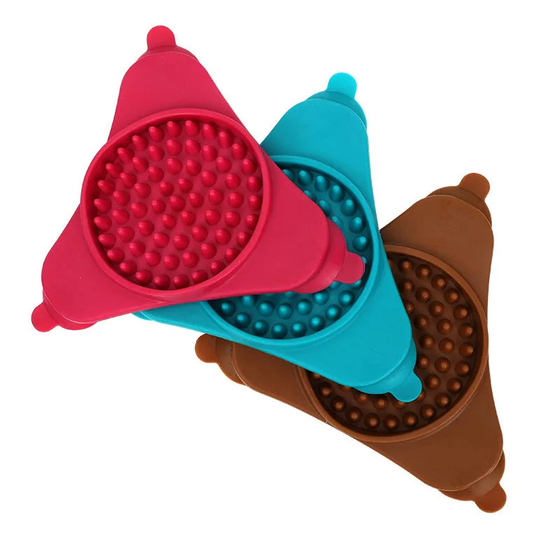 A set of three silicone licking mats for pets in pink, blue, and brown colors.