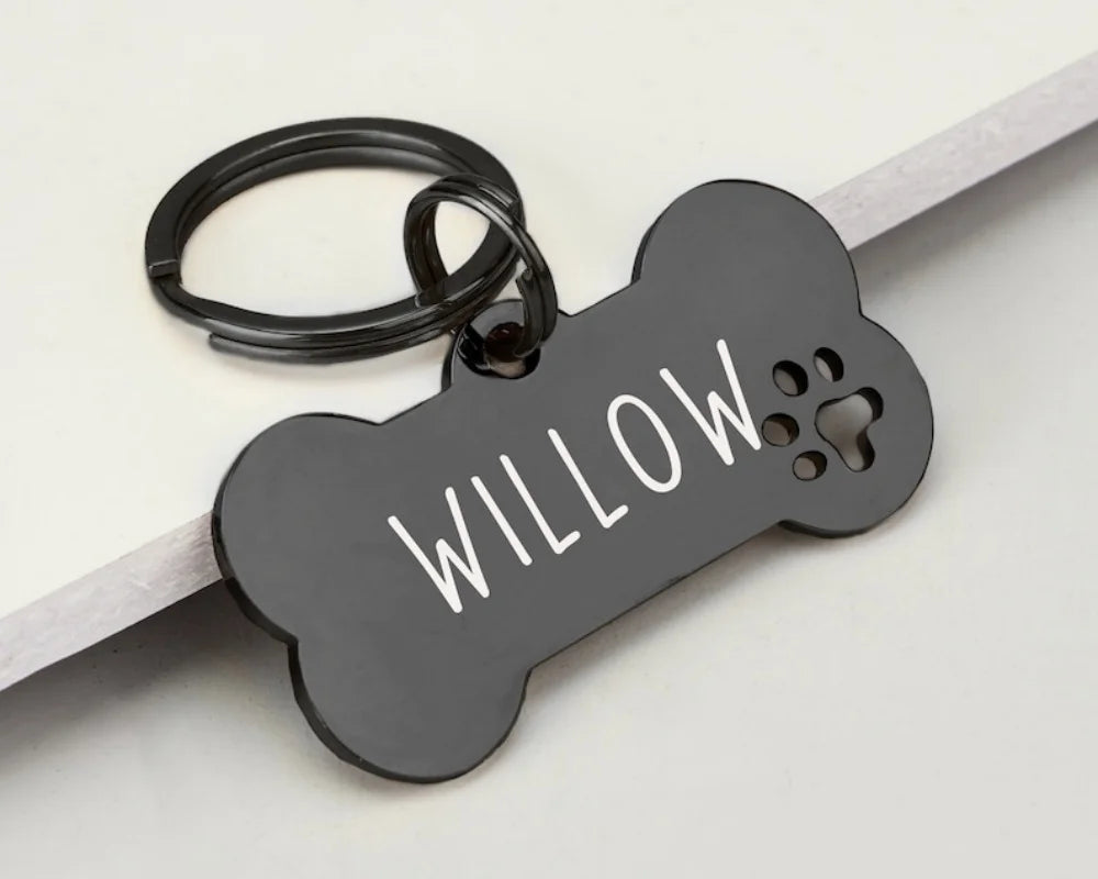 Black bone-shaped stainless steel dog ID tag engraved with the name Willow