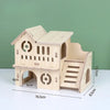 A natural wooden hamster house and activity platform with a pitched roof and stairs.