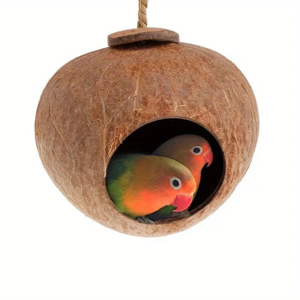 A natural coconut shell bird nest house with a hanging lanyard, showing the carved entrance.