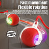 A red interactive rolling ball cat toy with a flexible tail is shown in motion, designed for cat play.