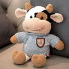 A soft cow plush toy with white and black markings, featuring large ears and a friendly expression.