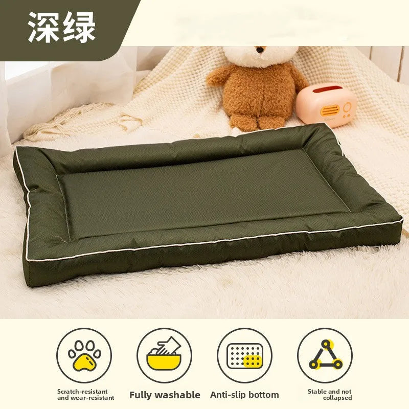 A dark olive green pet mat with a padded edge and anti-slip bottom is shown on a white fluffy surface.