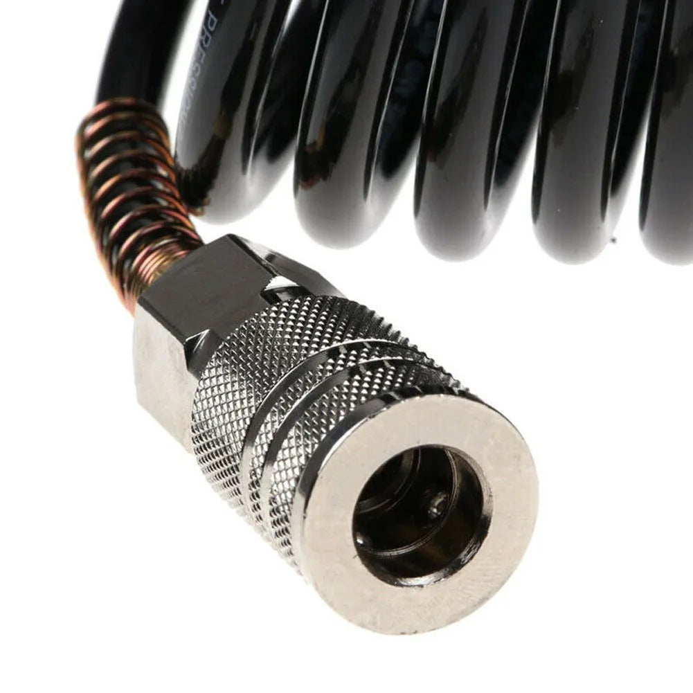 A close-up view of a black heavy-duty air compressor hose with a copper threaded fitting and a quick coupler adapter.