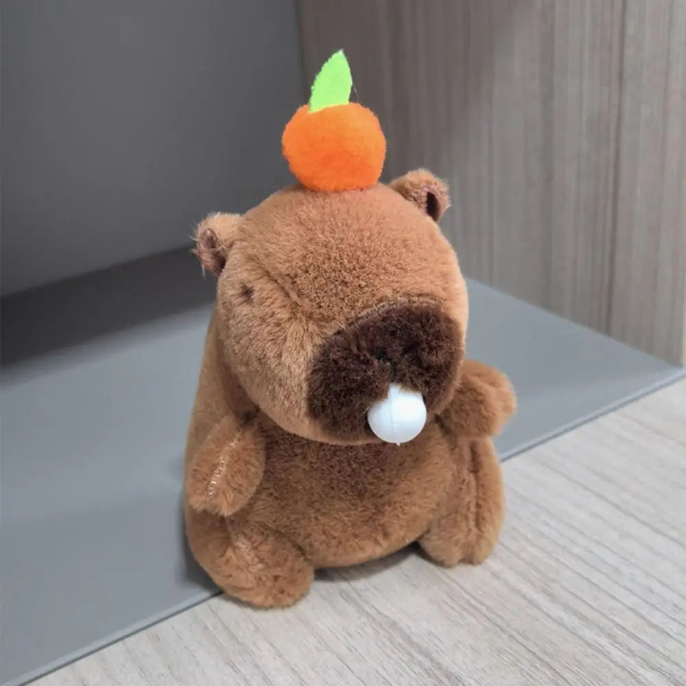 A brown capybara plush toy with orange ears and a green sprout on top.