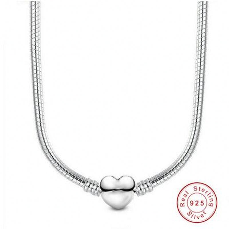 A silver snake chain necklace featuring a heart charm.