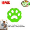 A bright green silicone pet hair remover tool is shown next to a piece of pet hair.