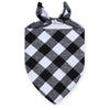 Black and white plaid bandana tied in a bow for a dog