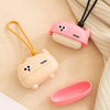 Pink and beige reusable pet hair roller with a cute cartoon design and attached string.