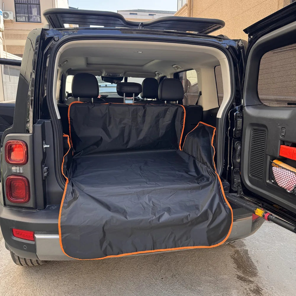 A black waterproof pet car seat cover is shown installed in the cargo area of a pickup truck.