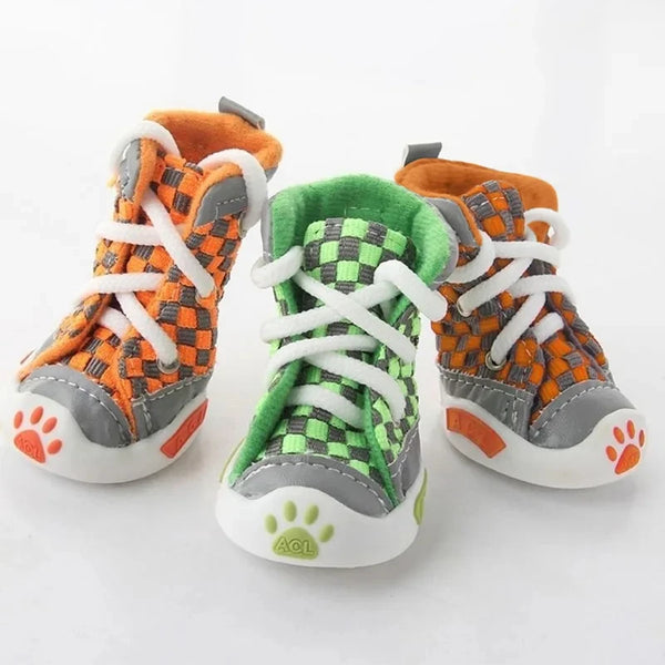 A set of four breathable anti-slip soft sole shoes for small dogs featuring orange and gray patterns.