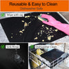 Reusable non-stick oven and grill liners shown being wiped with a rag and rinsed in the sink for dishwasher safe cleaning