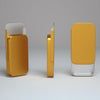A compact sliding lid tin box in gold and clear plastic, shown from the side.
