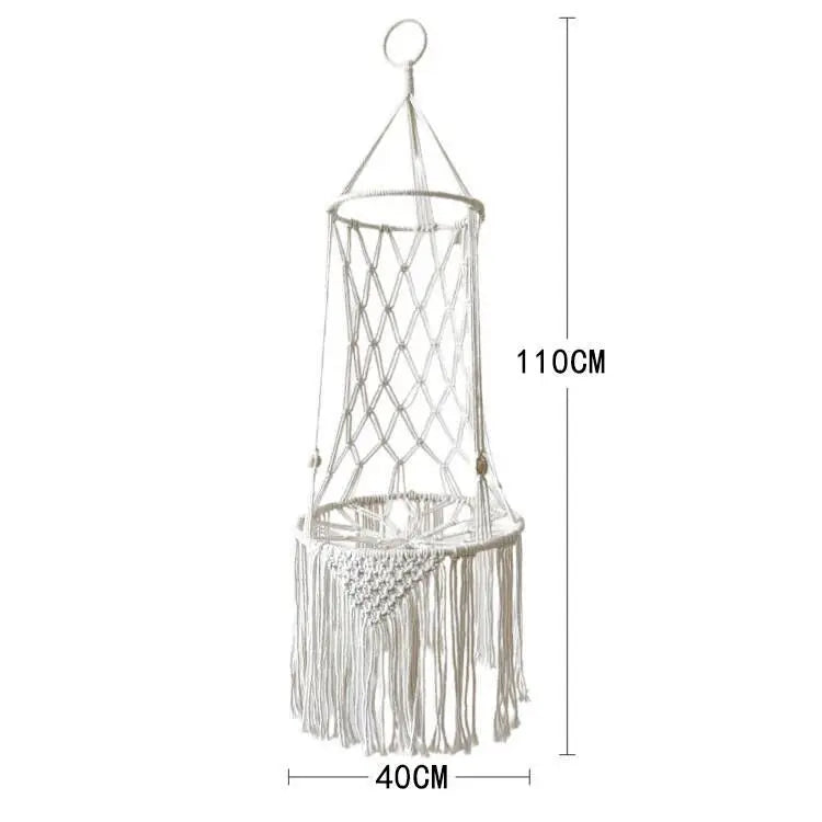 A bohemian macrame cat hammock bed for pet decor made of light-colored rope and fringe.