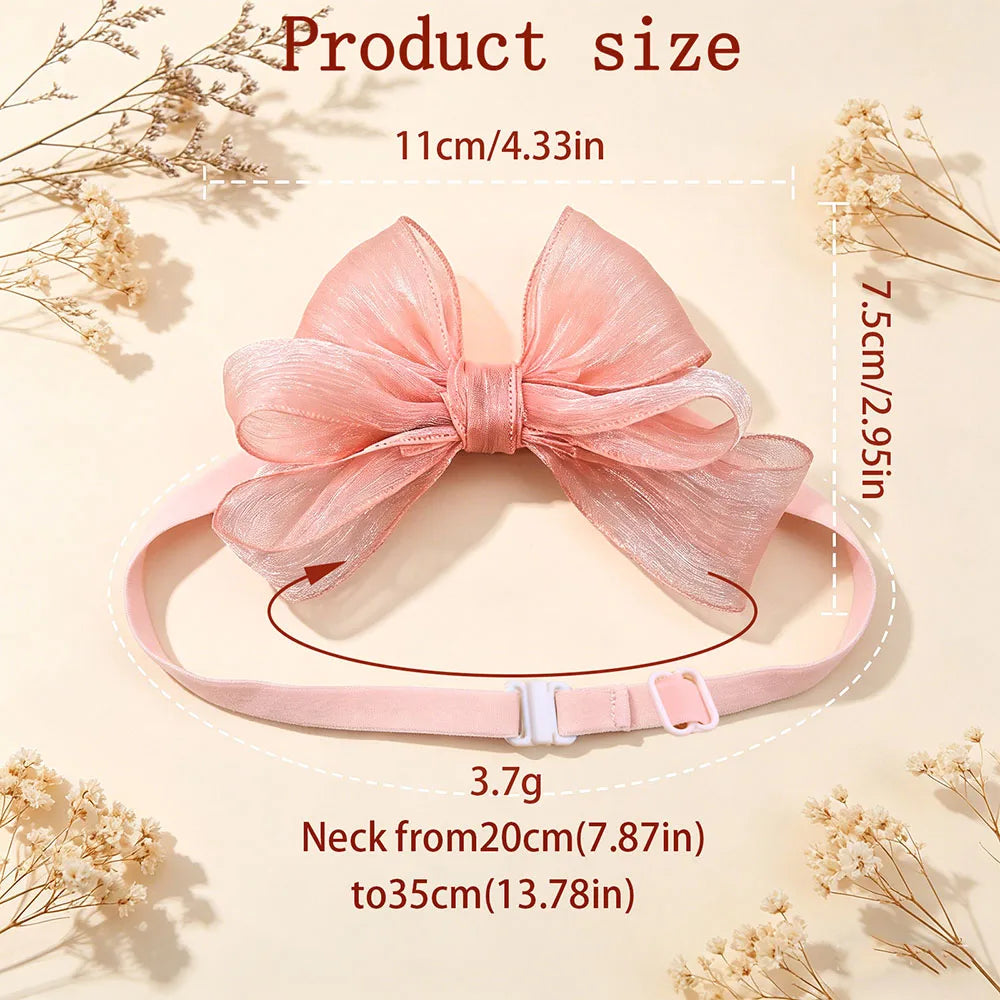 A pink satin bow set for a dog, measuring 11cm long and 7.5cm wide.