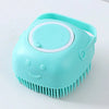 A light blue silicone pet bath massage brush with a foam maker feature.