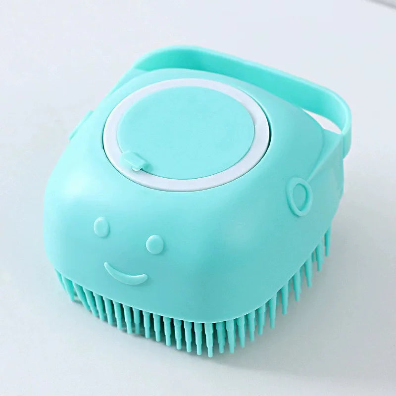 A light blue silicone pet bath massage brush with a foam maker feature.