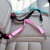 Colorful retractable dog car seatbelt tethers in black, blue, and pink attached to a car seat.