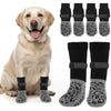 A golden retriever is sitting, displaying anti-slip dog socks in various patterns and colors for paw protection.