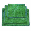 A rectangular green artificial grass dog training mat with a dark border.