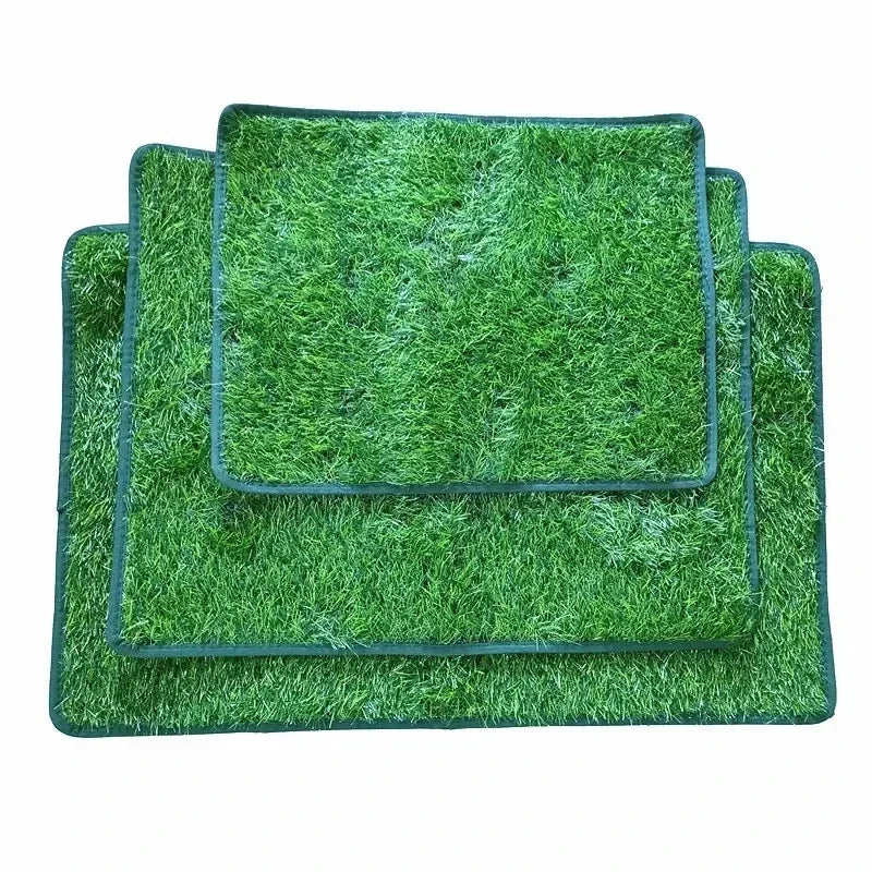 A rectangular green artificial grass dog training mat with a dark border.