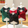 Three display mannequins show warm fleece dog tuxedo costumes with bow ties in green, black, and red.