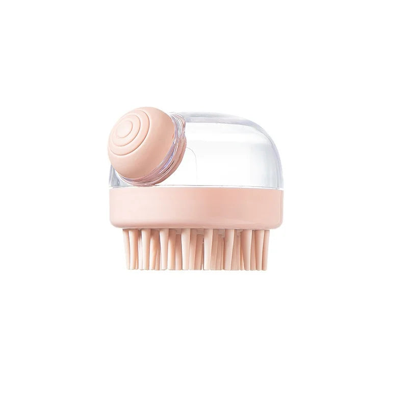 A pink silicone pet bath brush with a clear shampoo dispenser and bristles.
