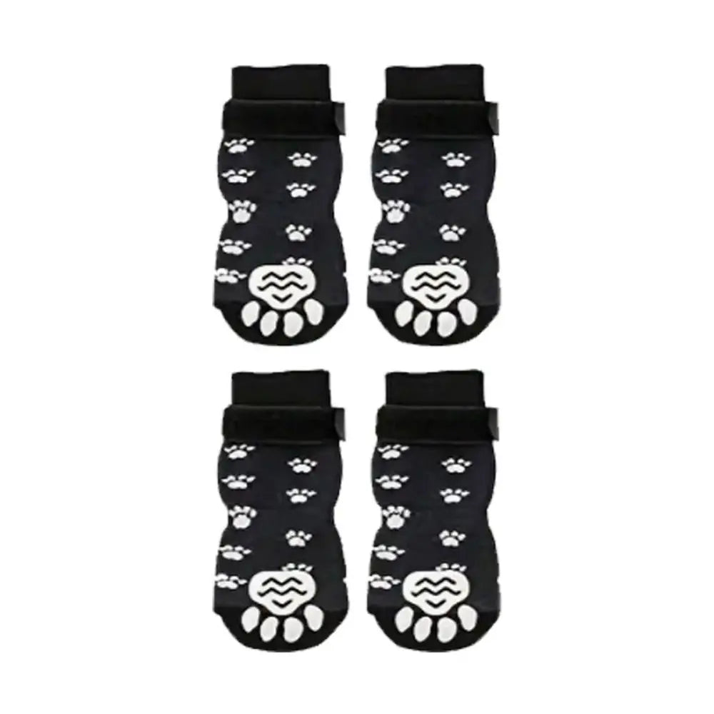 A pair of black breathable anti-slip dog socks featuring white paw print designs.