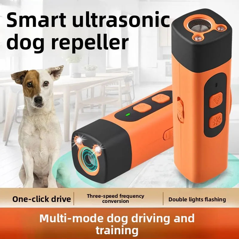 An orange and black portable ultrasonic dog repellent device is shown next to a dog.