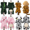 A collection of soft fleece dog jumpsuits and hoodies in various colors and patterns displayed on mannequins.
