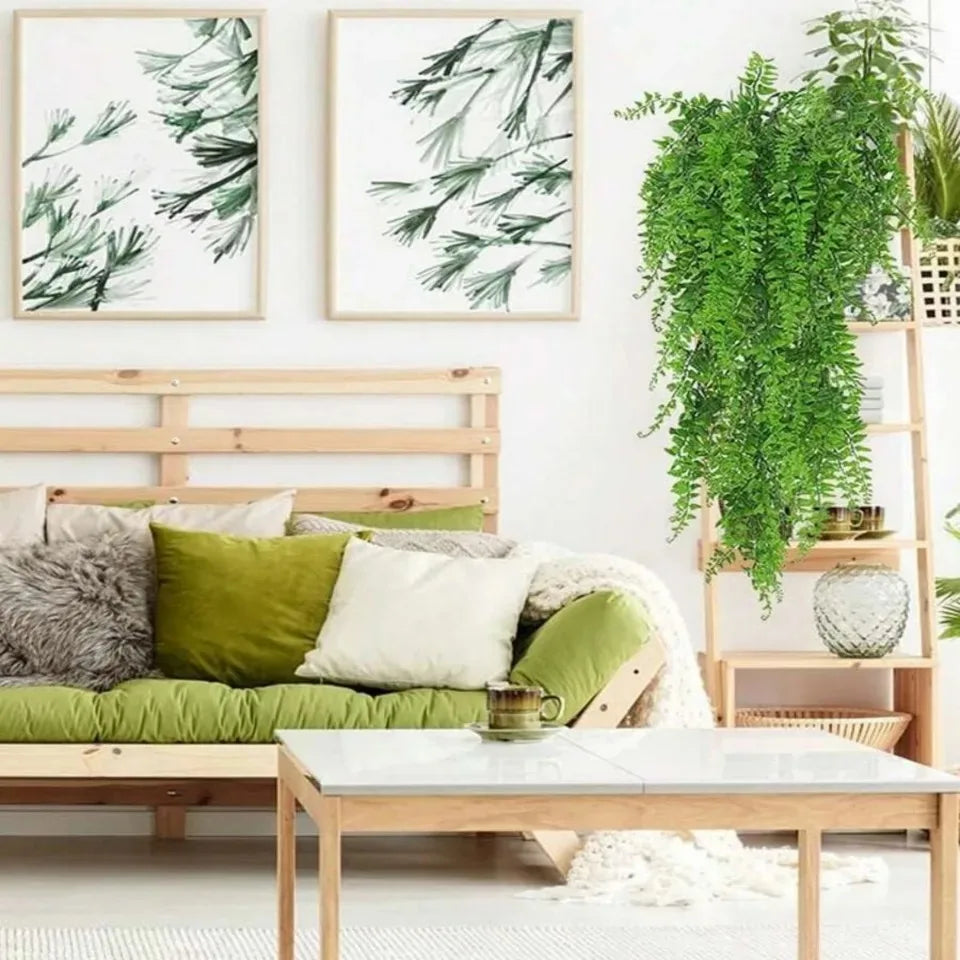 A set of four artificial Persian fern hanging vines in various shades of green displayed on a wooden shelf.
