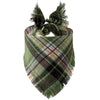 A plaid dog bandana featuring green, brown, and black tartan fabric with fringed edges.