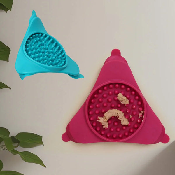 A pink silicone licking mat for pets with suction cups is shown against a white background.