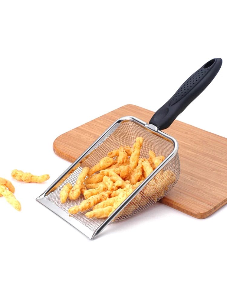 Stainless steel pet poop shovel with a black handle resting on a wooden board, filled with yellow pellets.