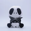 A white and black cartoon skeleton dog plush toy with stitched features and a black collar.