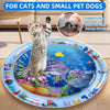 A blue pet water sensory mat with fish and food decorations is shown next to a cat.