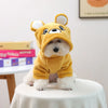 A fluffy, golden yellow seasonal flannel hoodie for a small dog sits on a white table.