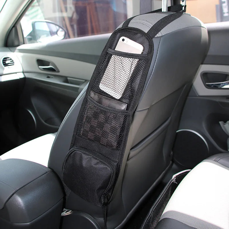 A black car backseat organizer with a mesh tablet holder and storage pockets installed on the seat.